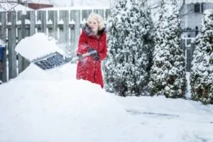 Woman Shoveling her Parking Lot