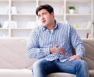 Man suffering from pain at home