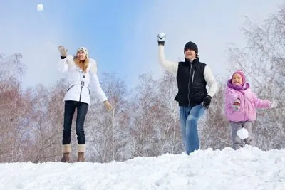 Happy family playing snowball