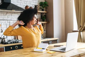 An african-american young woman is using laptop