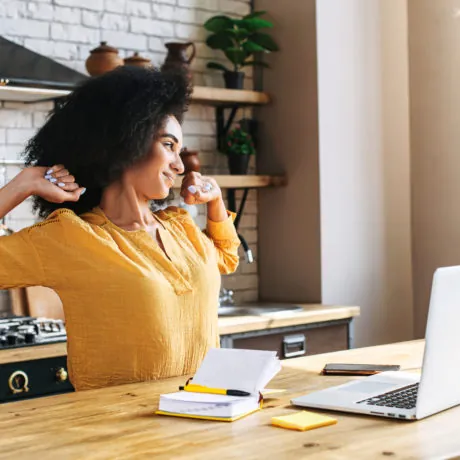 An african-american young woman is using laptop