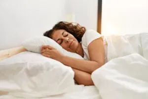 Middle age hispanic woman sleeping on the bed at bedroom