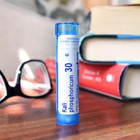 Blog: Kali phos on table with reading glasses and stack of books