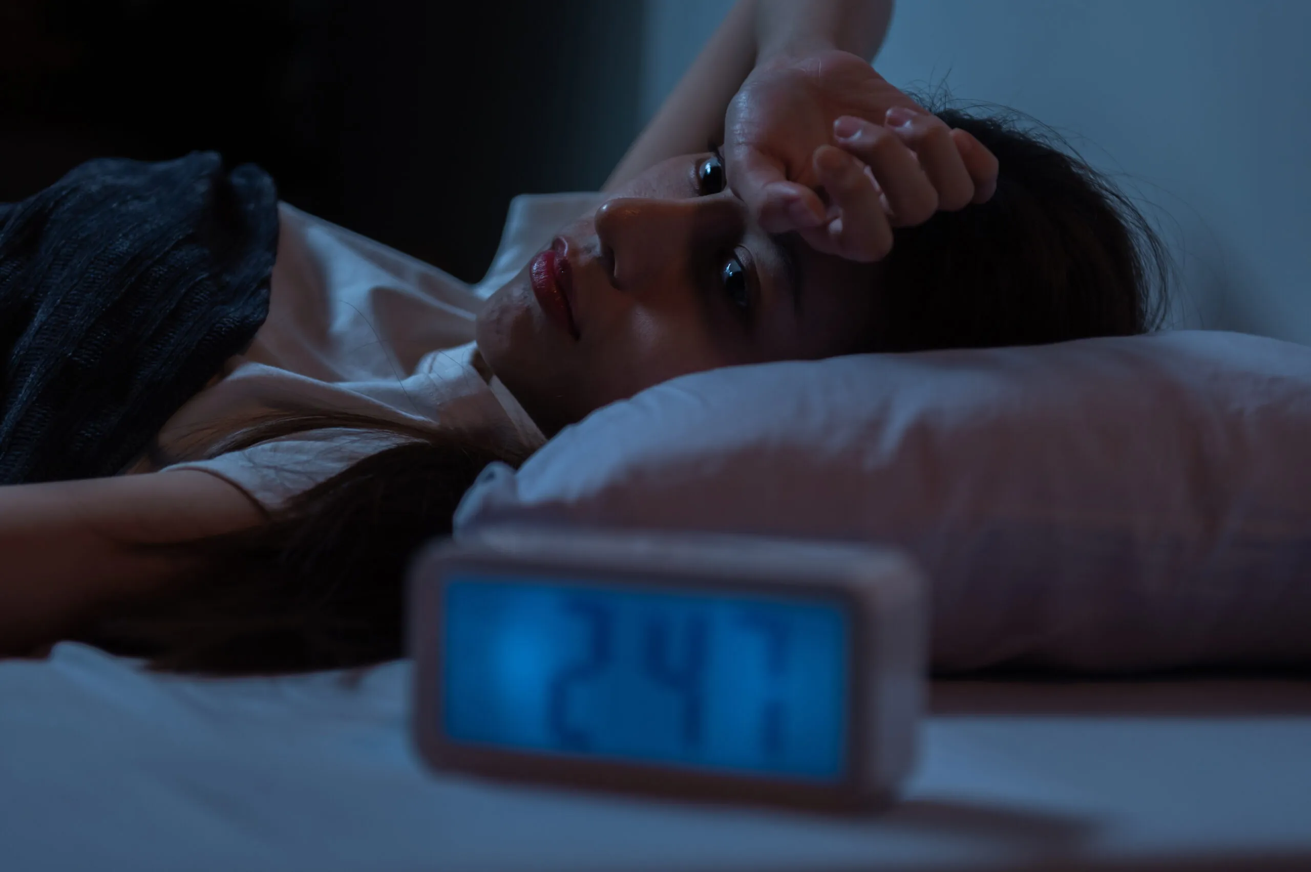 Young Asian woman suffer from insomnia can’t sleep at night awaken from stress mental health problem or migraine. Young people health care psychiatry concept.