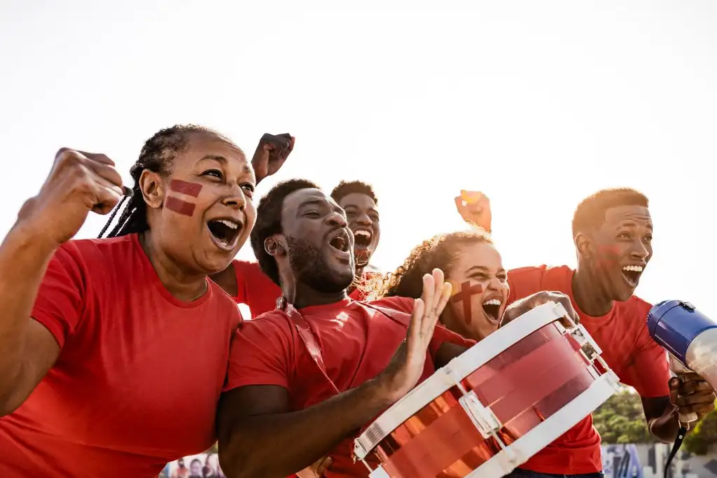 African football fans having fun cheering their favorite team – Soccer sport entertainment concept